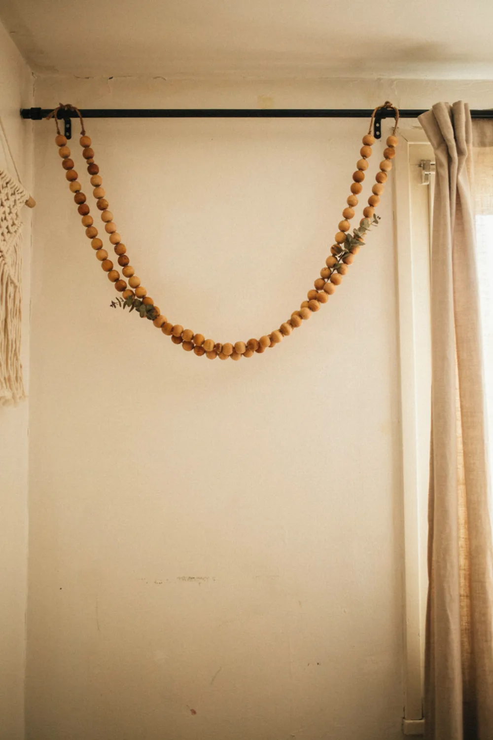 Small cozy boho bedroom: string Wooden Beads Over the Window