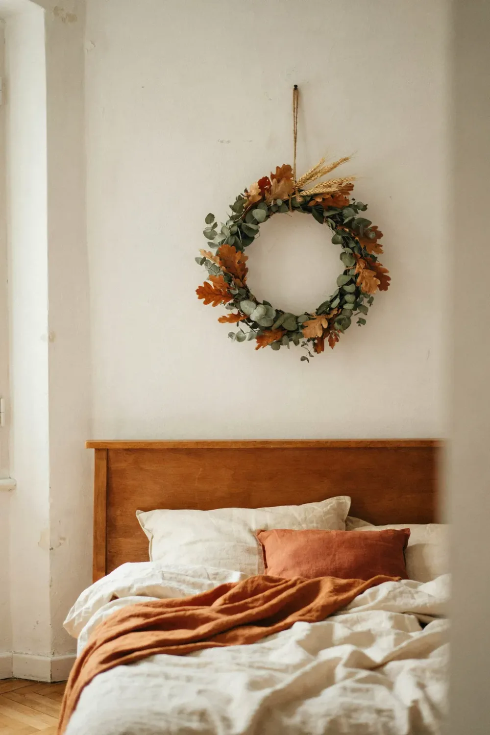 Cozy fall bedroom in warm feminine tones: hang a Fall Wreath Over the Headboard