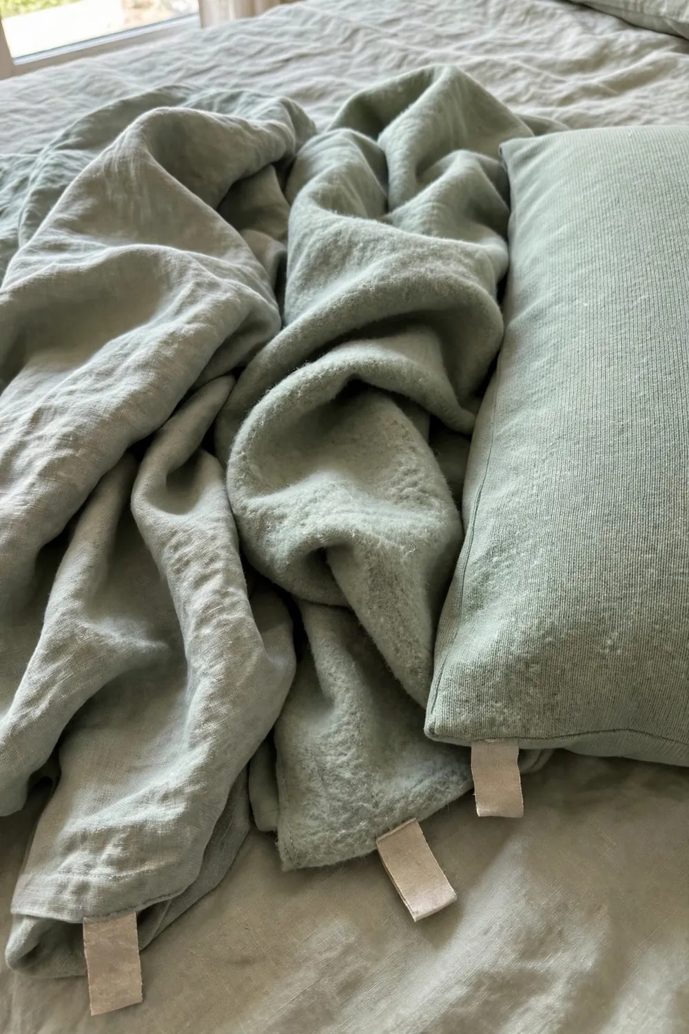 Warm sage green bedroom: fold a Cream Quilt Over Sage Bedding