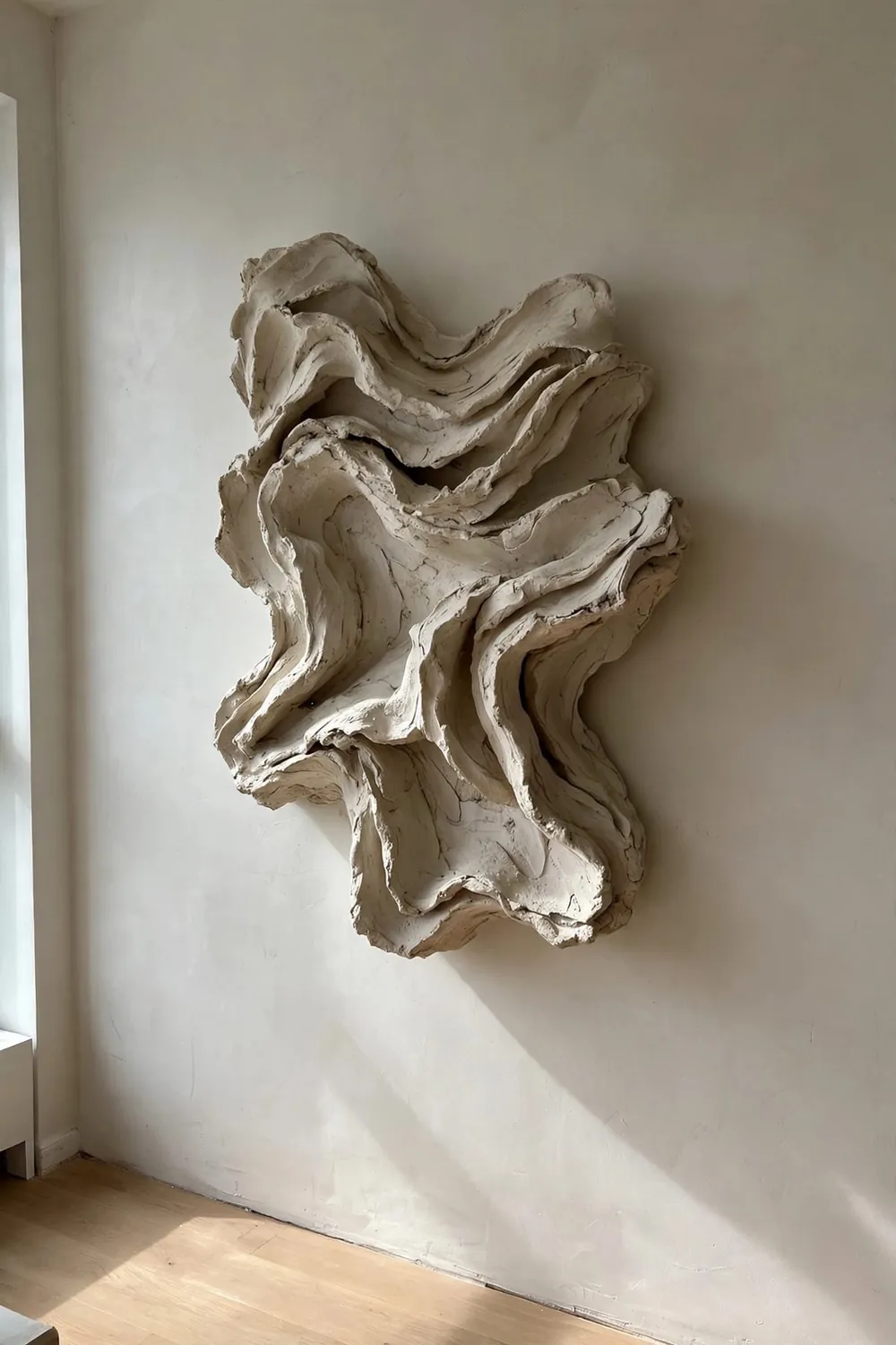 Modern living room with large sculptural wall art: go Oversized With One Statement, Skip the Rest